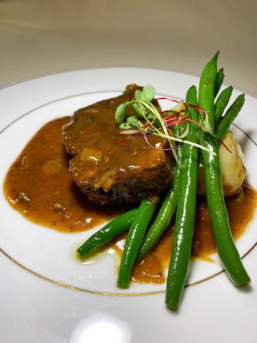 Blackened Wild Boar Meatloaf with mashed potatoes, haricots verts, Guinness onion gravy